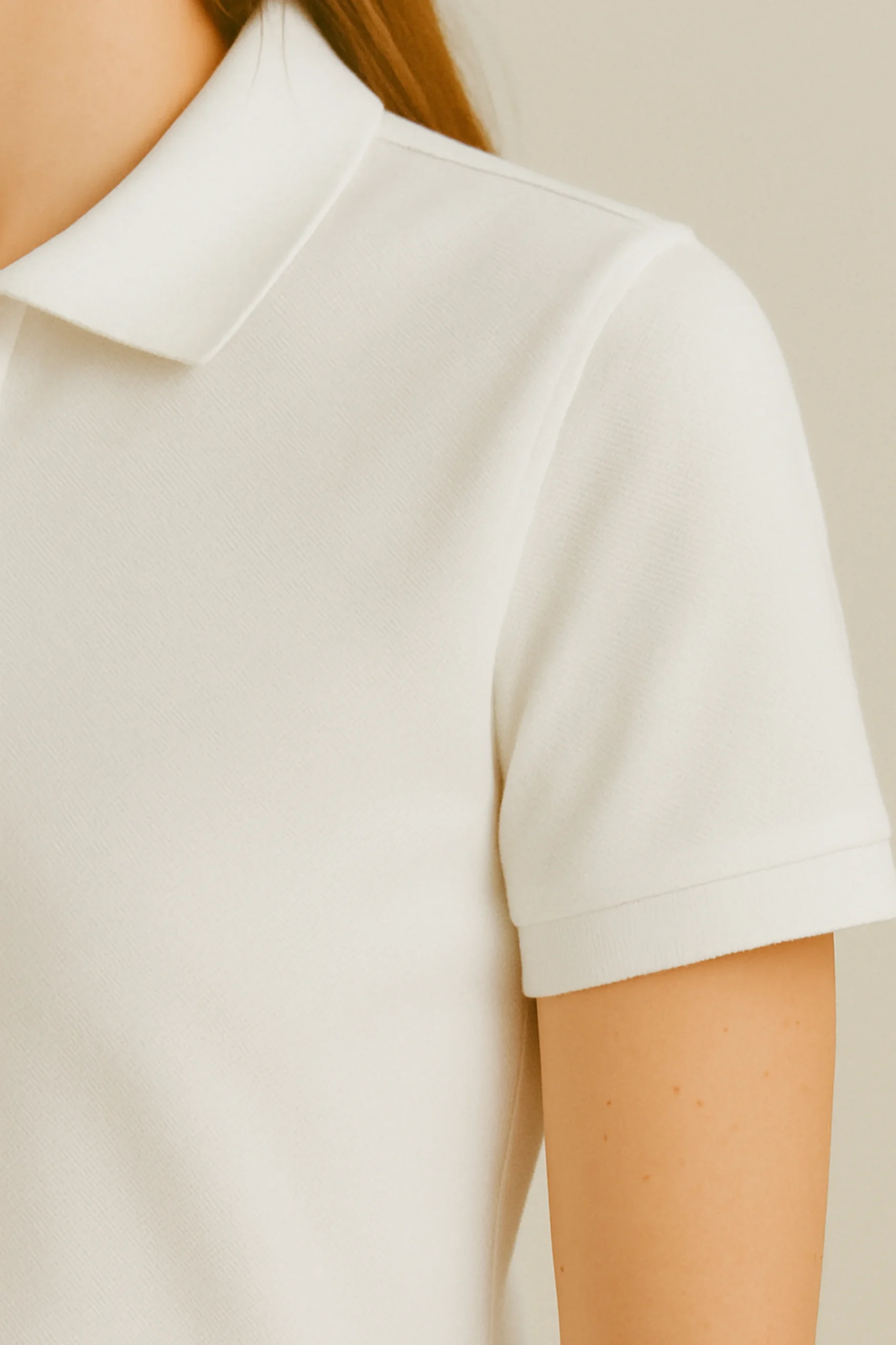 White polo t-shirt crafted from premium cotton blend double piqué fabric with short sleeves, buttoned collar, and classic regular fit